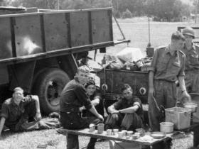 Breakfast 1966 - This was taken on exercise in the Northern Rivers.  I can't recognise all these blokes, I'm sitting next to the CL truck, Sgt Ben Wiggan and Sgt Burroughs at the rear of the trailer.  Rex Devlin is far right with the dixies.  I can't plac